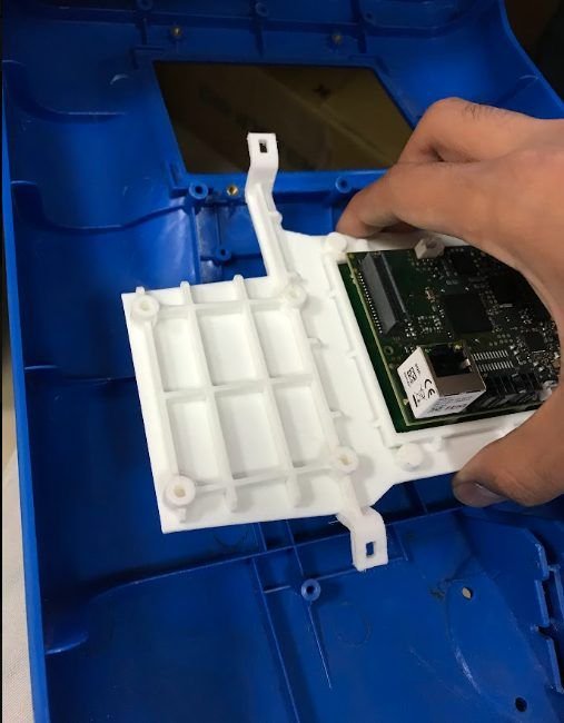 Hands fitting the white module into the blue gate housing