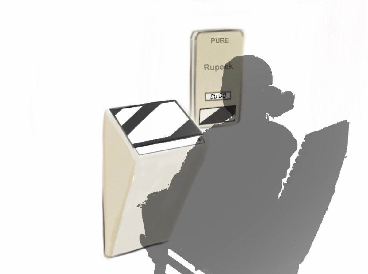 Silhouette of a person using a desk-height kiosk shaped like a gold biscuit